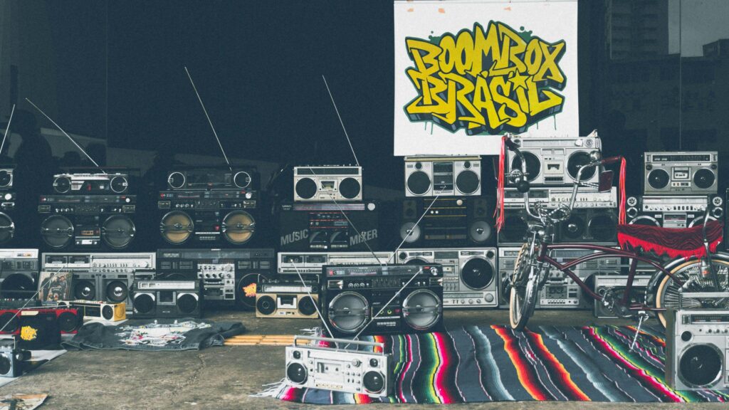 Retro boombox collection and vintage bicycle with vibrant graffiti backdrop.